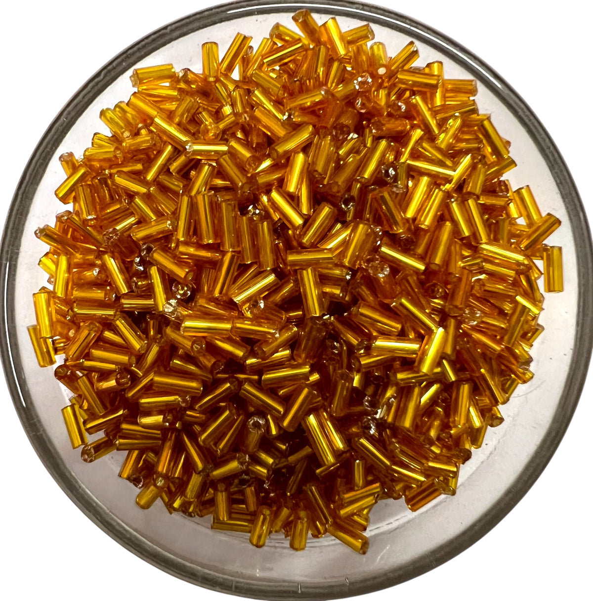 Loose metallic golden yellow glass tube beads for DIY jewelry making on a white background.