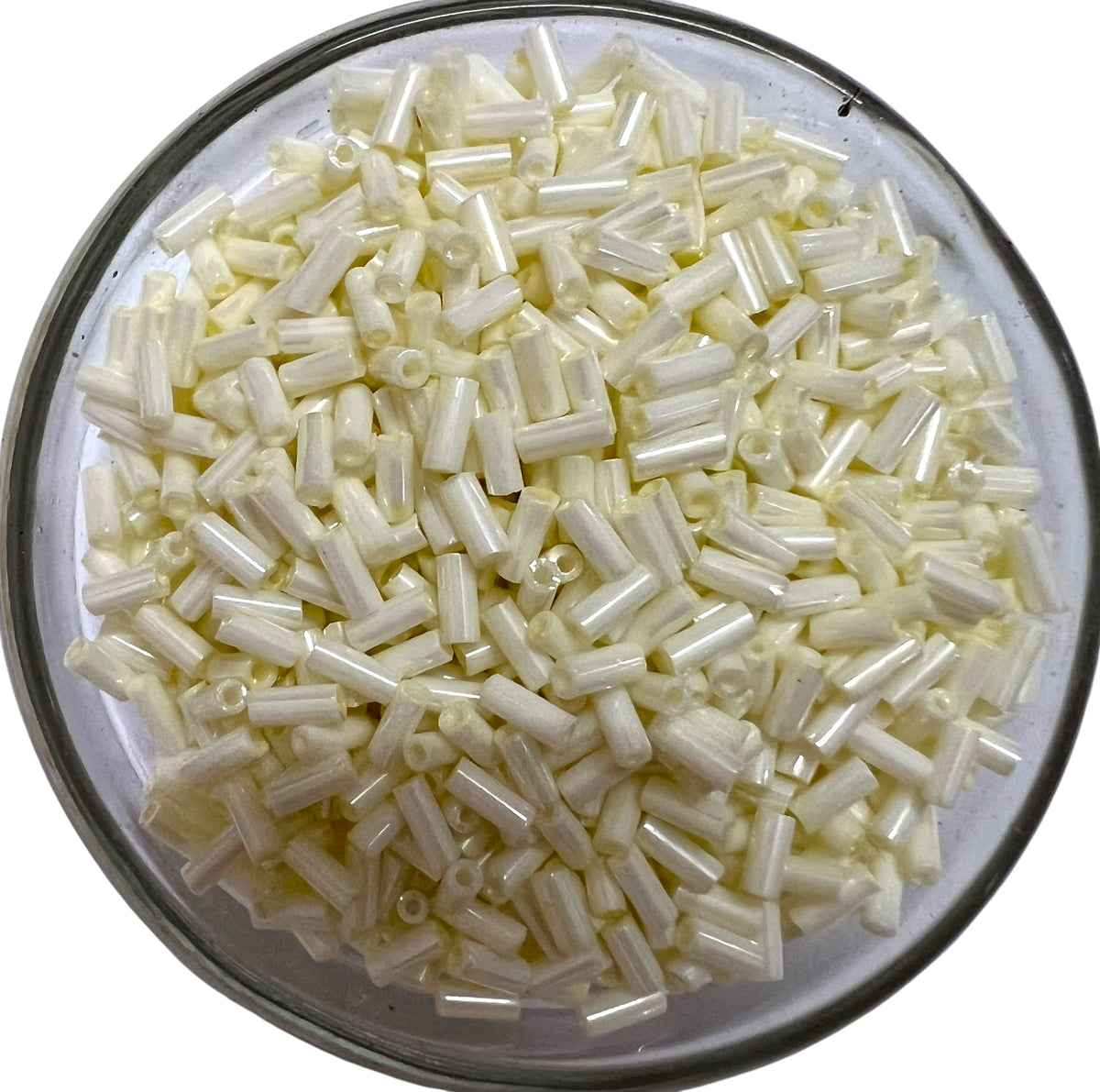 Loose metallic cream glass tube beads for DIY jewelry making on a white background.