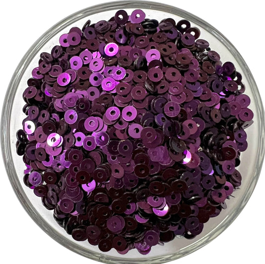 Close-up of 3mm dark purple metal sequins with a shiny metallic finish, perfect for intricate Aari embroidery, hand embroidery, and DIY jewelry making.