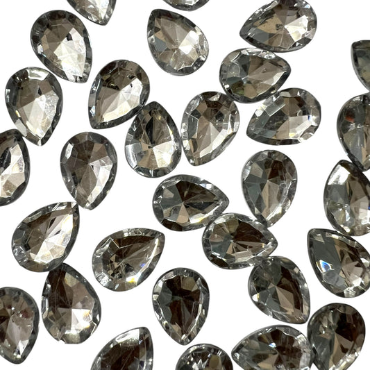 Pack of faceted white 10x14mm oval acrylic stone beads with shiny crystal-cut edges for jewelry making and craft projects